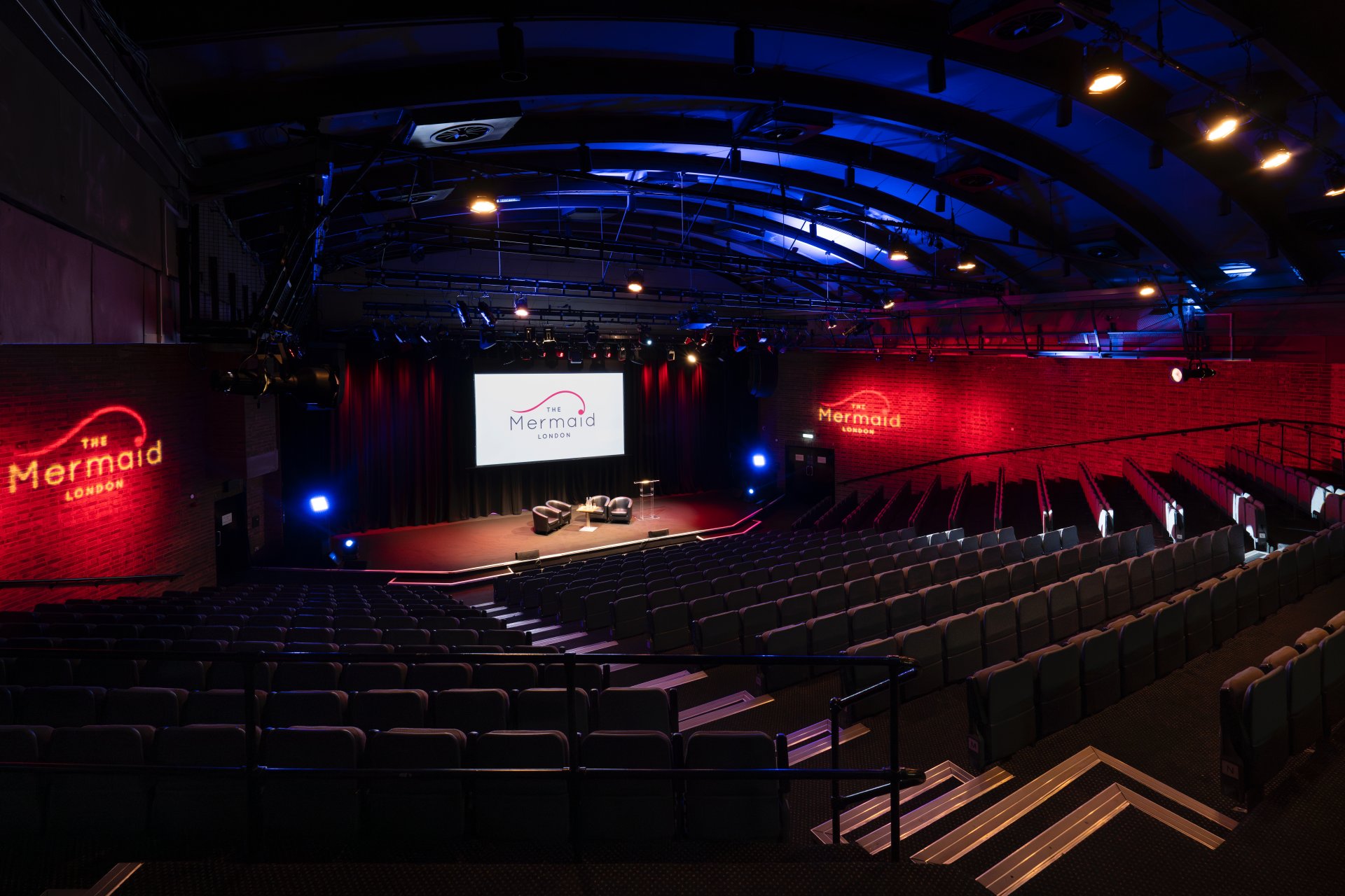 a theater with a stage and chairs