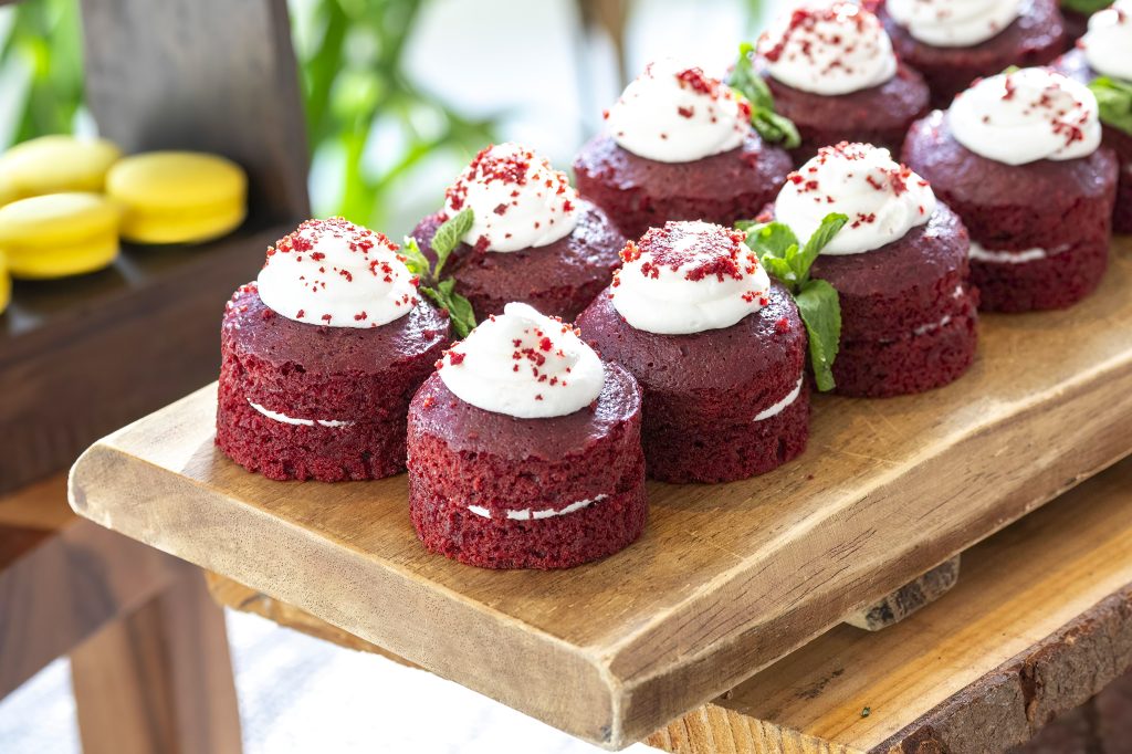 Private Dining 4 a group of red velvet cupcakes on a wood board